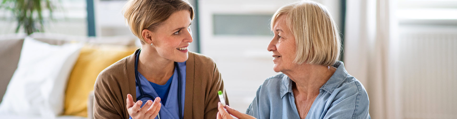 caregiver talking with an elderly woman