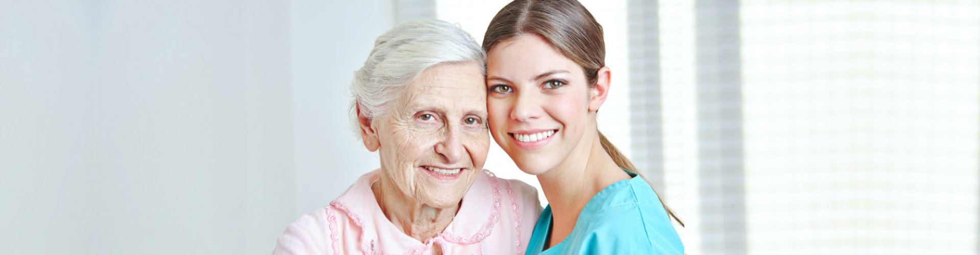 caregiver smiling with elderly woman