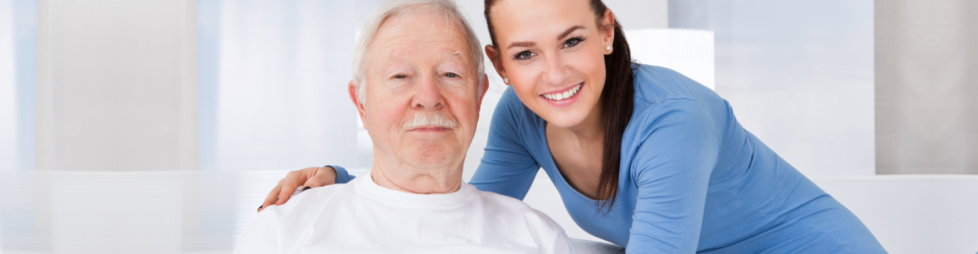 caregiver attending to an elderly man