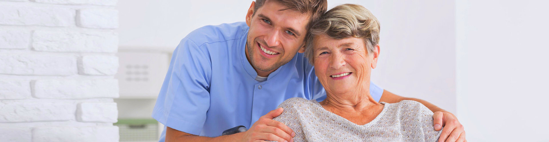 caregiver smiling with elderly woman