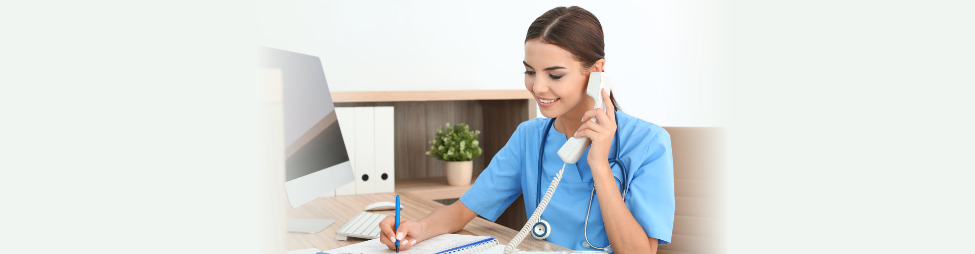 Female medical assistant taking a phone call